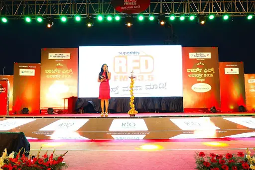 Red FM awards stage with a host on a fully branded set