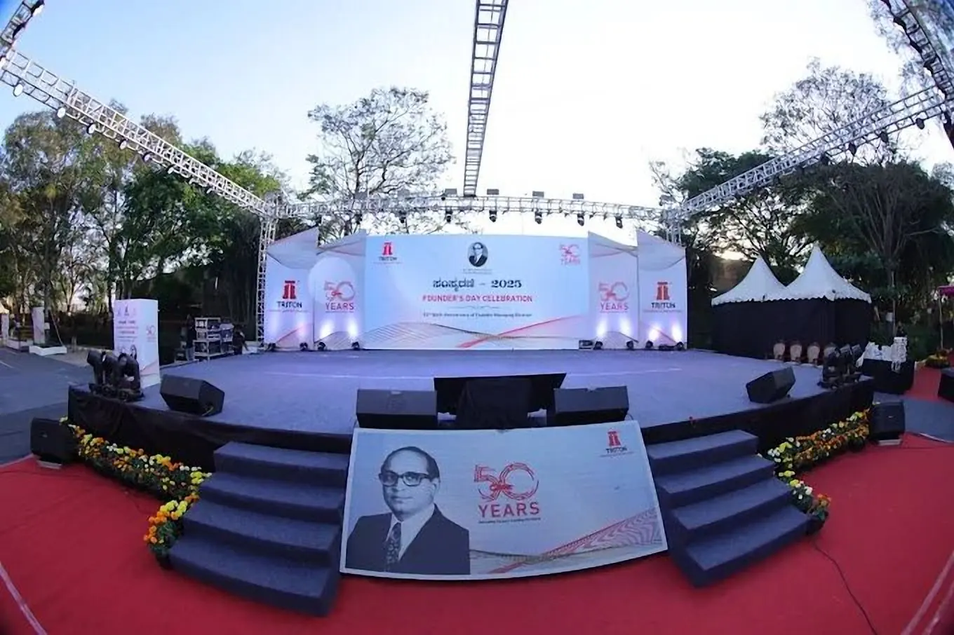 Triton 50 years founders day stage with tiered platform and truss rig